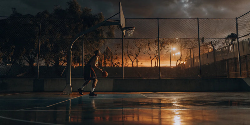 Basketball player using passing training equipment.