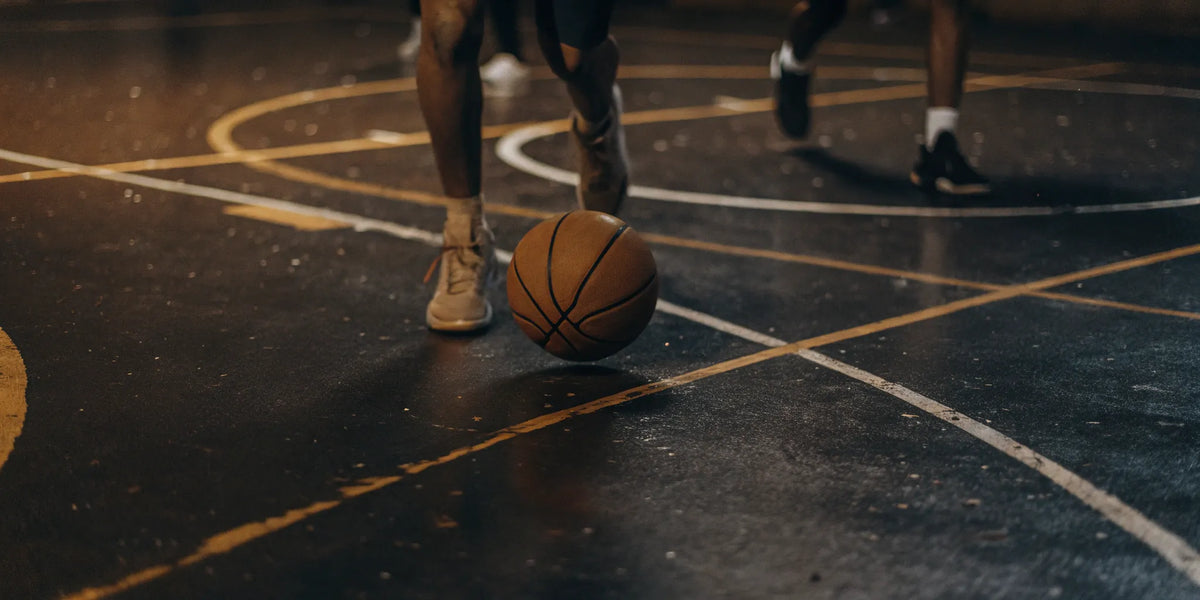 A basketball team running dribbling drills for improved ball control.