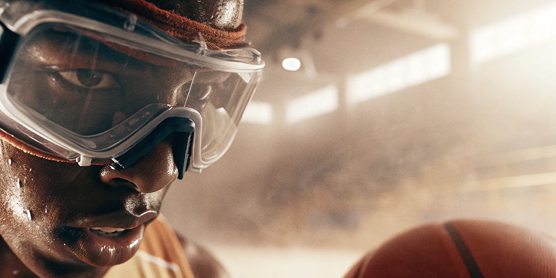 A basketball player trains with dribbling goggles to improve court vision and ball control.