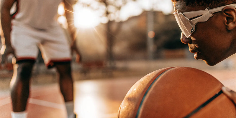 Basketball player uses dribble glasses to work on keeping their head up while dribbling.