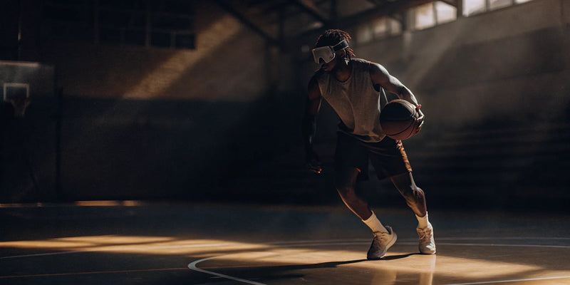 Basketball player improving their dribble with Dribble Master training goggles.