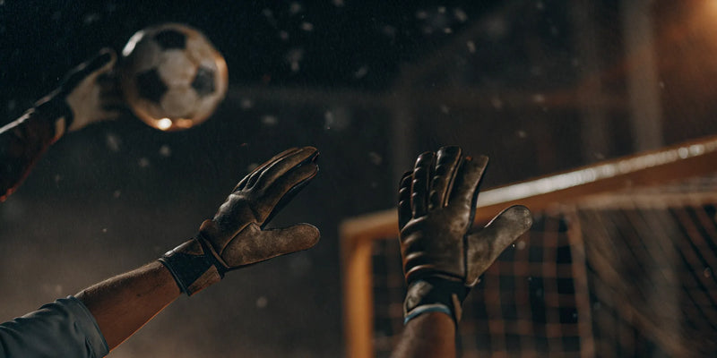 Goalkeeper using the best reaction training equipment to block a soccer ball.